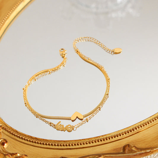Exquisites und modisches Herz aus 18 Karat Gold mit doppellagigem Design-Fußkettchen „LOVE“.