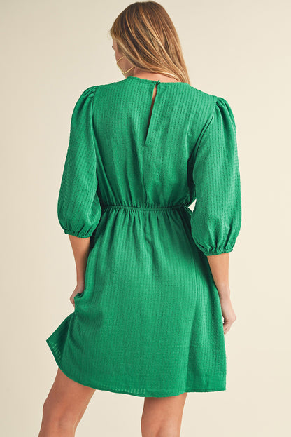 Mini-robe de couleur unie à col rond et manches bouffantes vert foncé