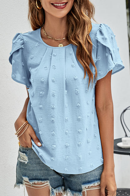 Nebelblaue Bluse aus Schweizer Punktjacquard mit Blütenblättern und Ärmeln