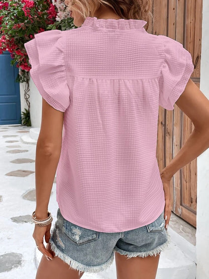 Blouse à volants et mancherons crantés