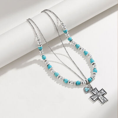 Doppellagige Kreuzkette mit künstlichen türkisfarbenen Perlen